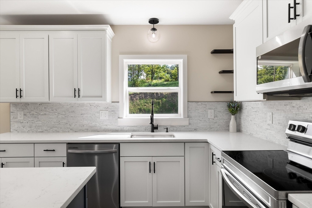 8 Wilson Street Spencer, MA 01562 - Photo 13 of 41 a kitchen with stainless steel appliances granite countertop a sink a stove and cabinets