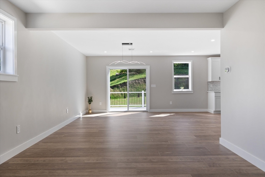 8 Wilson Street Spencer, MA 01562 - Photo 18 of 41 an empty room with wooden floor and windows