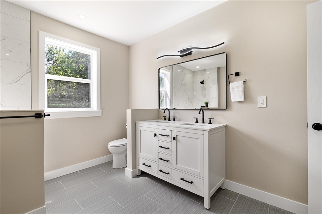 8 Wilson Street Spencer, MA 01562 - Photo 24 of 41 a bathroom with a double vanity sink a mirror and a toilet