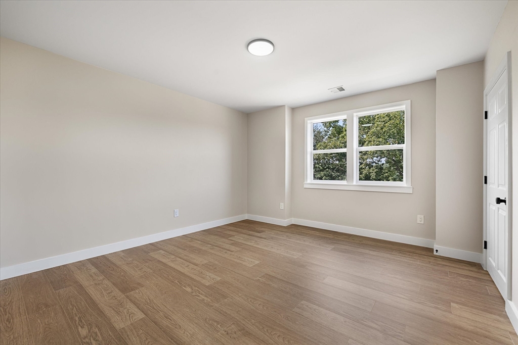 8 Wilson Street Spencer, MA 01562 - Photo 26 of 41 an empty room with wooden floor and windows