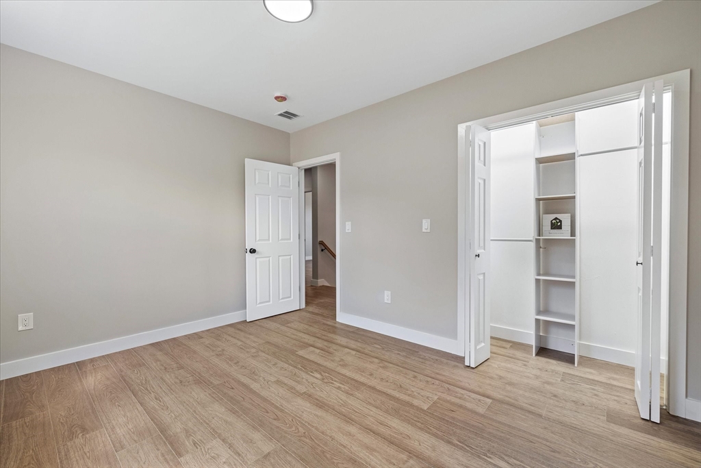 8 Wilson Street Spencer, MA 01562 - Photo 30 of 41 a view of an empty room with wooden floor and closet