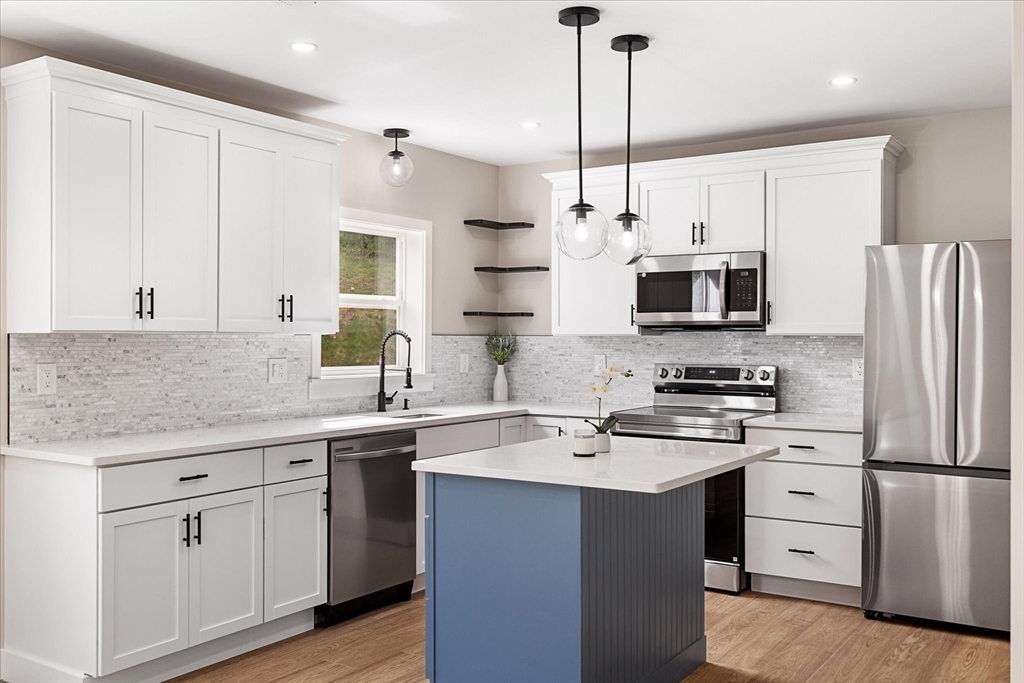 8 Wilson Street Spencer, MA 01562 - Photo 8 of 41 a kitchen with stainless steel appliances a sink stove and refrigerator