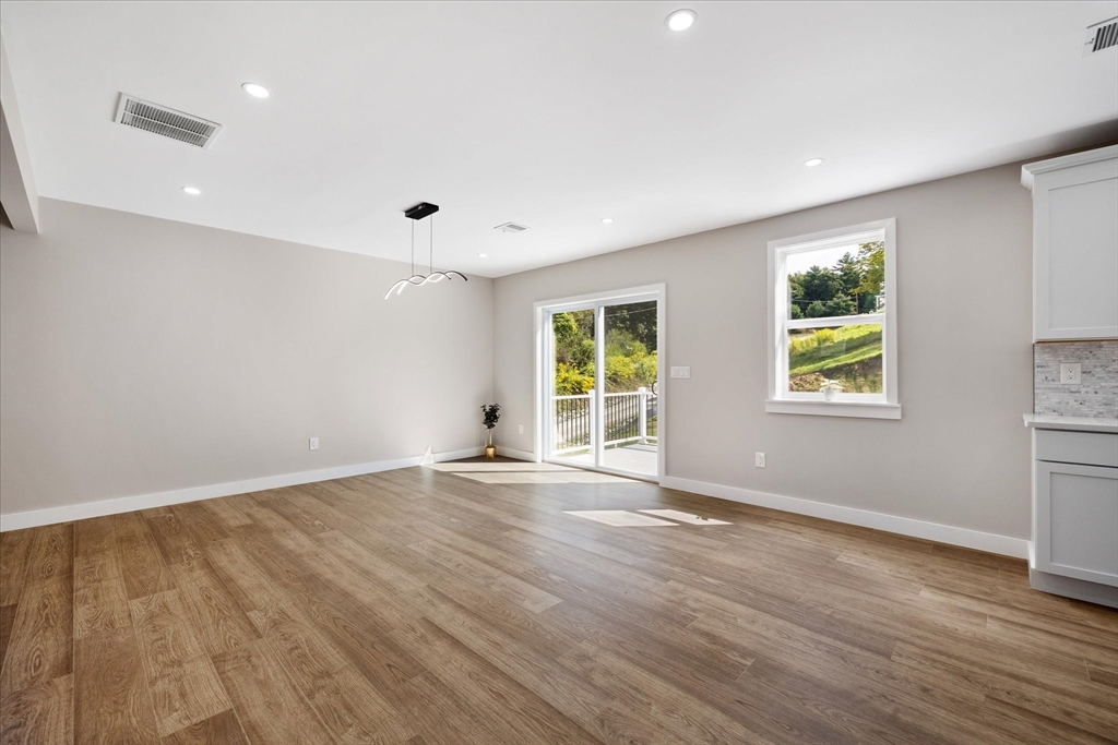 8 Wilson Street Spencer, MA 01562 - Photo 9 of 41 an empty room with wooden floor and windows