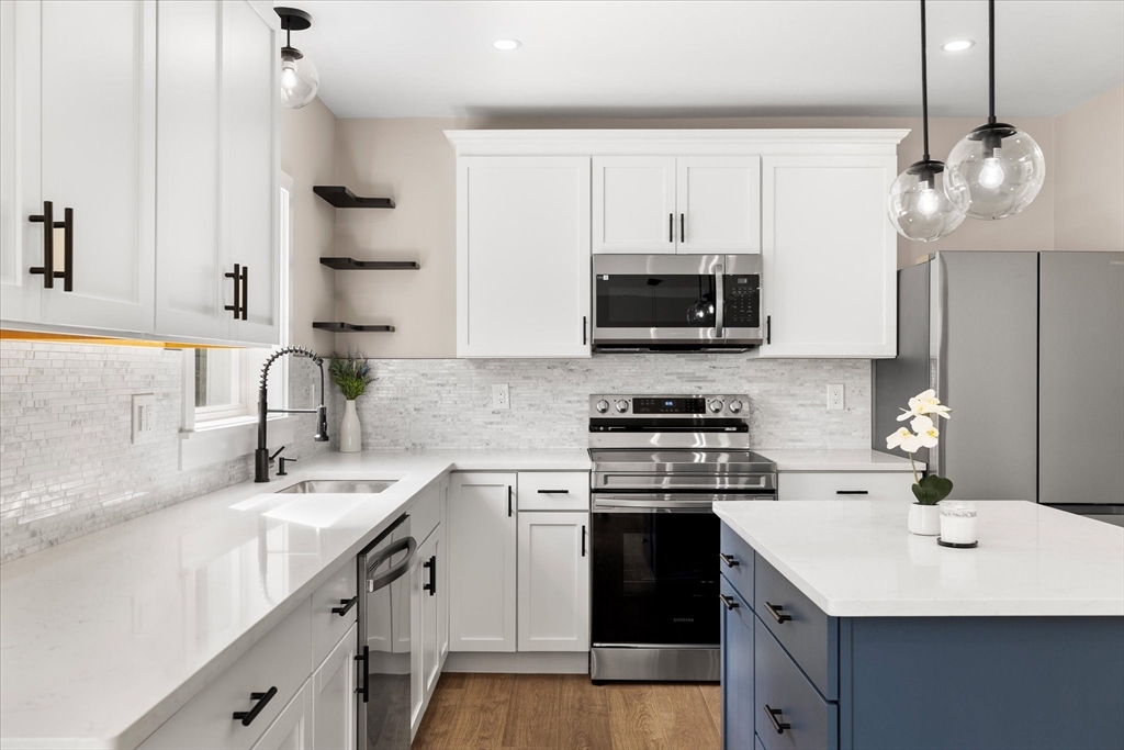 8 Wilson Street Spencer, MA 01562 - Photo 10 of 41 a kitchen with a sink a stove and a microwave