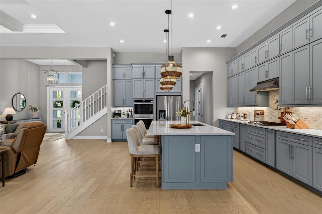 8331 Redonda Loop Lakewood Ranch, FL 34202 - Photo 18 of 92 a kitchen with stainless steel appliances kitchen island granite countertop a sink and cabinets