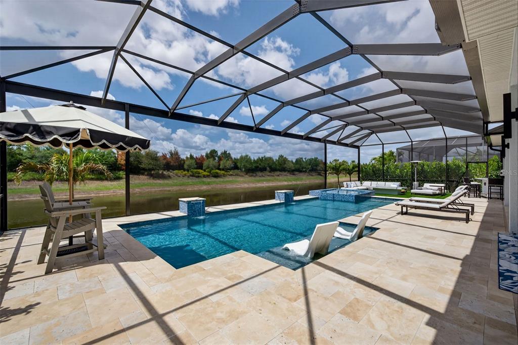 8331 Redonda Loop Lakewood Ranch, FL 34202 - Photo 2 of 92 a view of a patio with a table and chairs under an umbrella