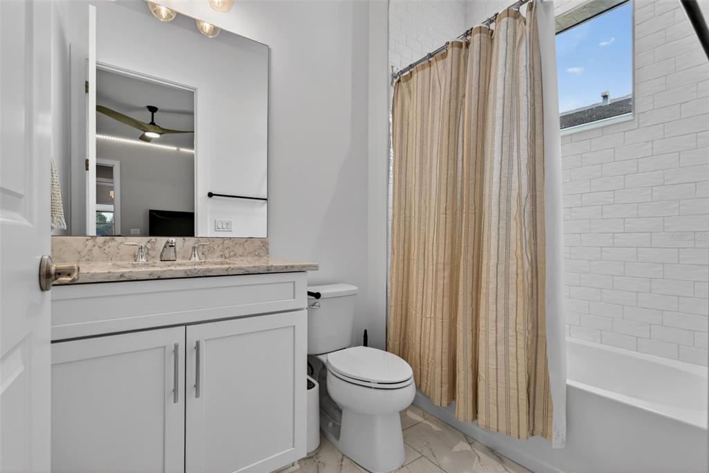 8331 Redonda Loop Lakewood Ranch, FL 34202 - Photo 37 of 92 a bathroom with a granite countertop sink toilet and shower