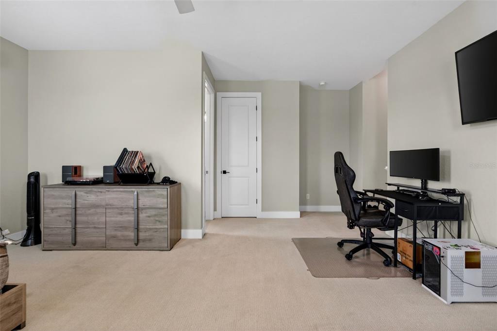 8331 Redonda Loop Lakewood Ranch, FL 34202 - Photo 48 of 92 a workspace with a couch and a flat screen tv