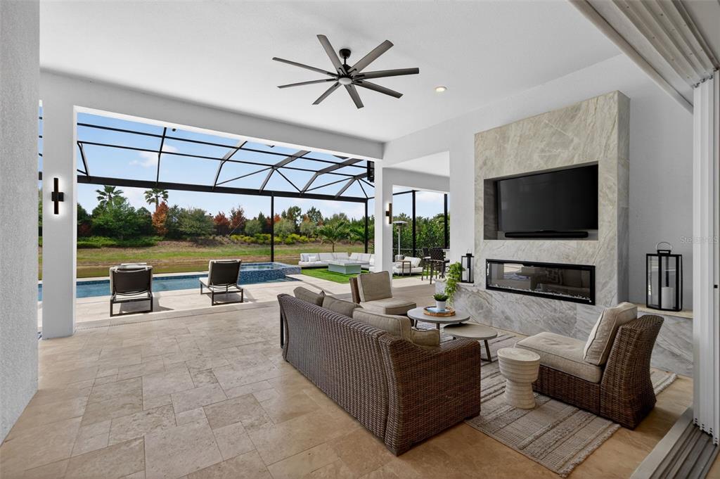 8331 Redonda Loop Lakewood Ranch, FL 34202 - Photo 52 of 92 a living room with couches a flat screen tv and a floor to ceiling window