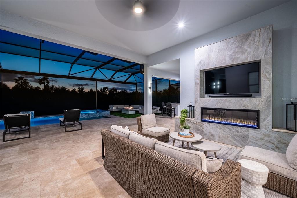 8331 Redonda Loop Lakewood Ranch, FL 34202 - Photo 53 of 92 a living room with furniture a flat screen tv and a large window