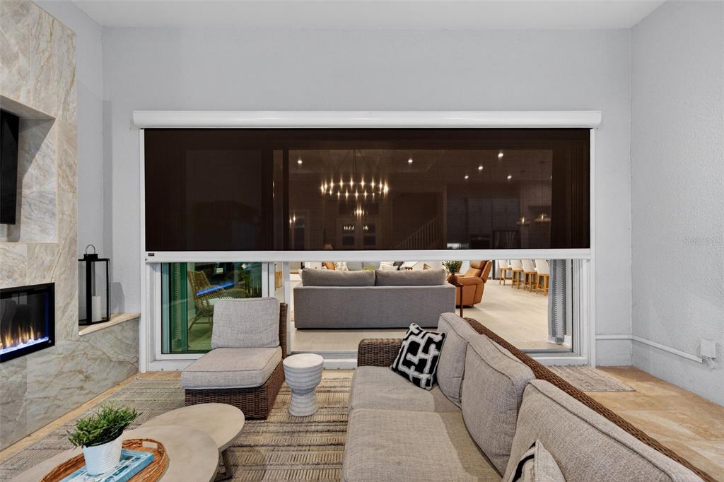 8331 Redonda Loop Lakewood Ranch, FL 34202 - Photo 56 of 92 a living room with furniture and a fireplace