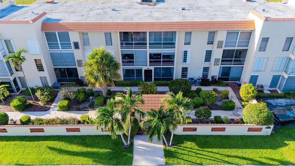331 Southwest 8th Street, Unit 1CE Boca Raton, FL 33432 - Photo 2 of 4 front view of house with a yard