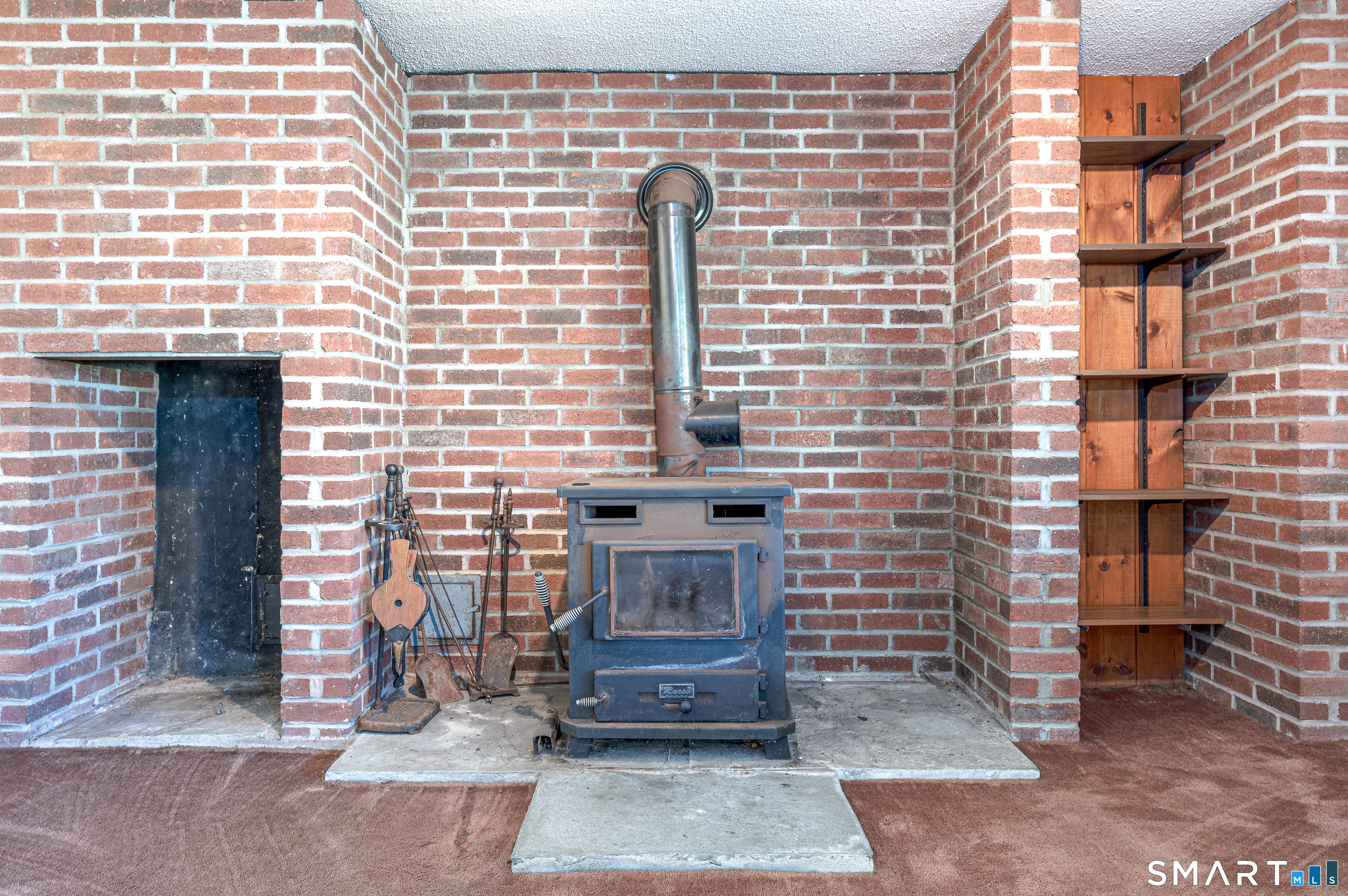 737 Leetes Island Road Guilford, CT 06437 - Photo 14 of 40 lower level wood stove
