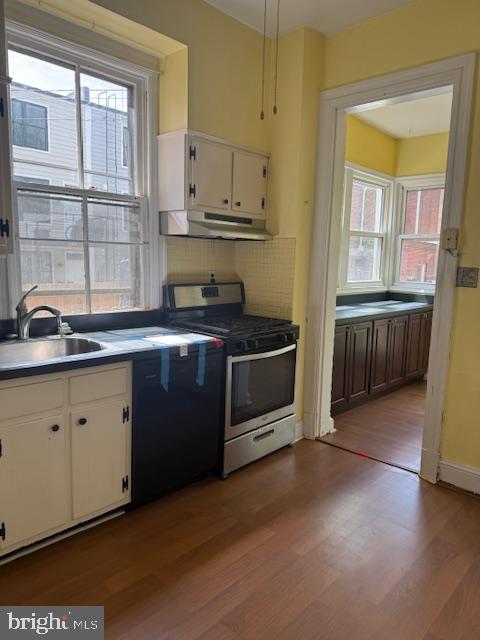 331 5th Street Southeast Washington, DC 20003 - Photo 8 of 27 a kitchen with stainless steel appliances granite countertop a stove a sink and a granite counter tops with white cabinets