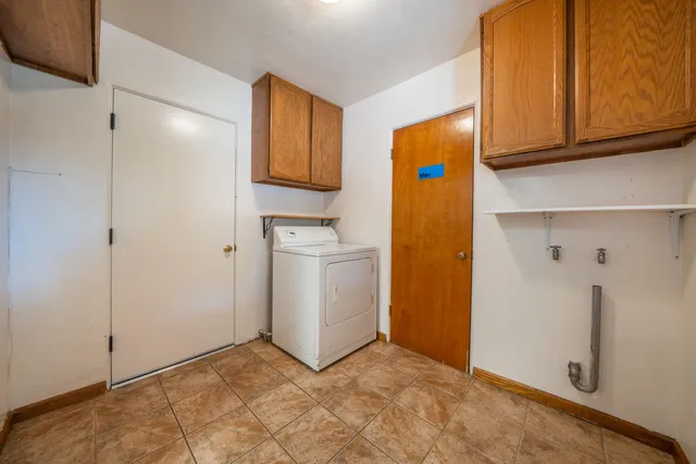 a front view of house with yard and trees in the background