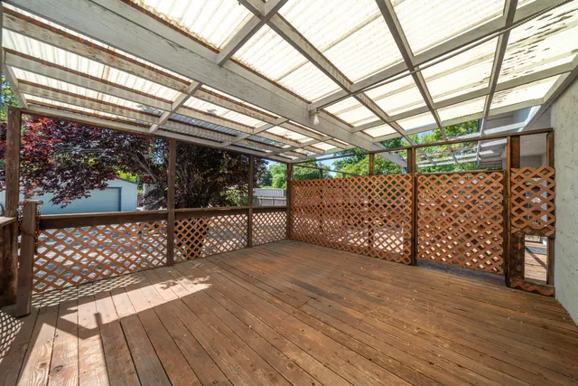 a front view of a house with a yard and tree