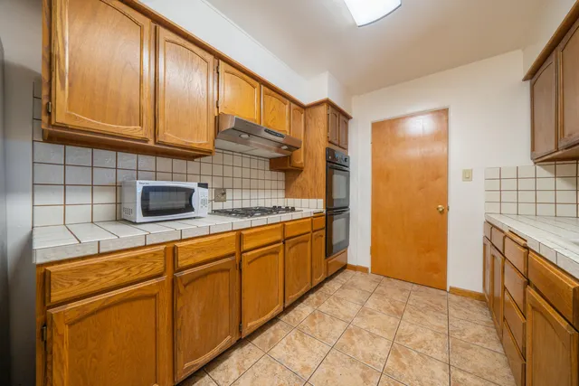 a kitchen with stainless steel appliances granite countertop a sink and cabinets