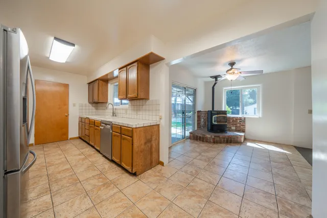 a view of an empty room with window and cabinet