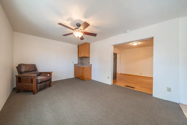 a living room with a fireplace and a floor to ceiling window