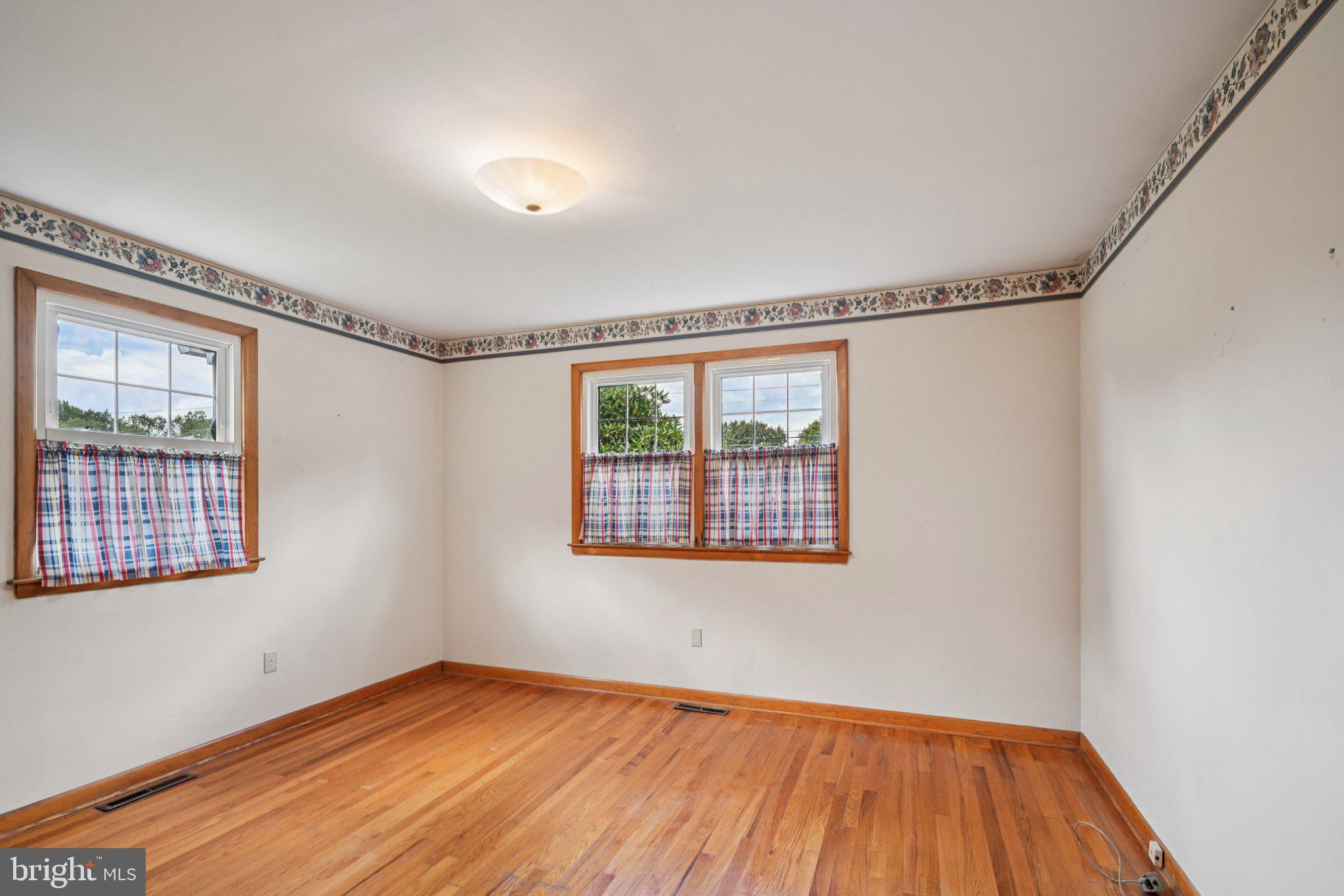 9 Cooper Tomlinson Road Medford, NJ 08055 - Photo 23 of 39 a view of an empty room with wooden floor and a window