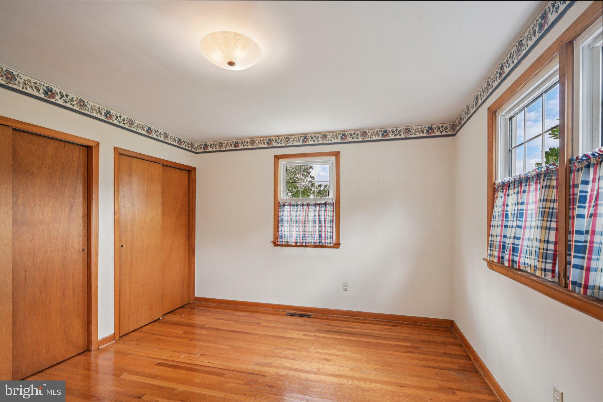 9 Cooper Tomlinson Road Medford, NJ 08055 - Photo 25 of 39 a view of an empty room with a window and wooden floor