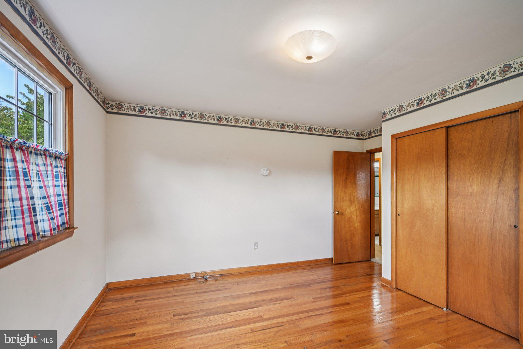 9 Cooper Tomlinson Road Medford, NJ 08055 - Photo 26 of 39 a view of room with hardwood floor and window