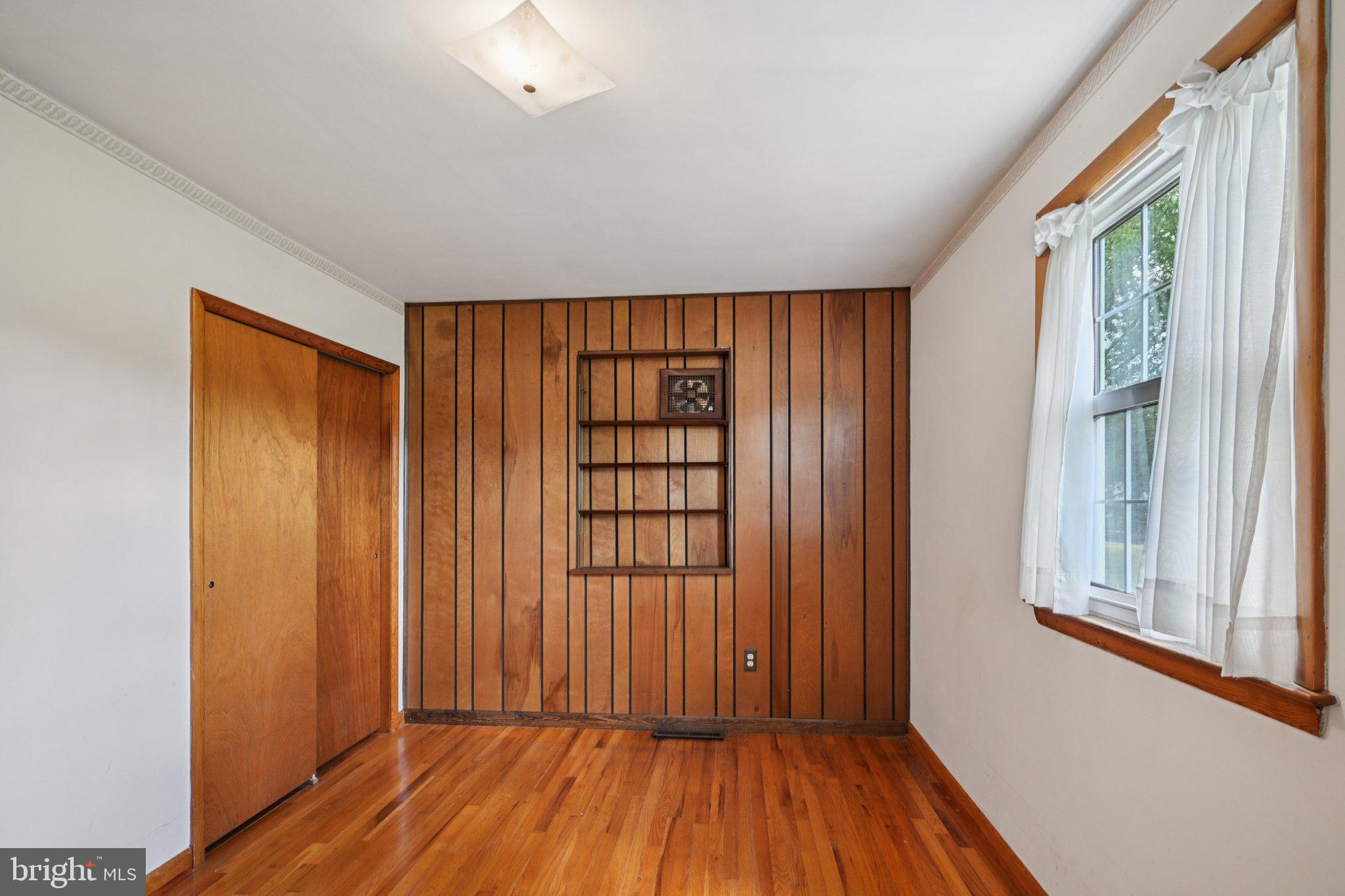 9 Cooper Tomlinson Road Medford, NJ 08055 - Photo 27 of 39 an empty room with wooden floor and windows with curtains