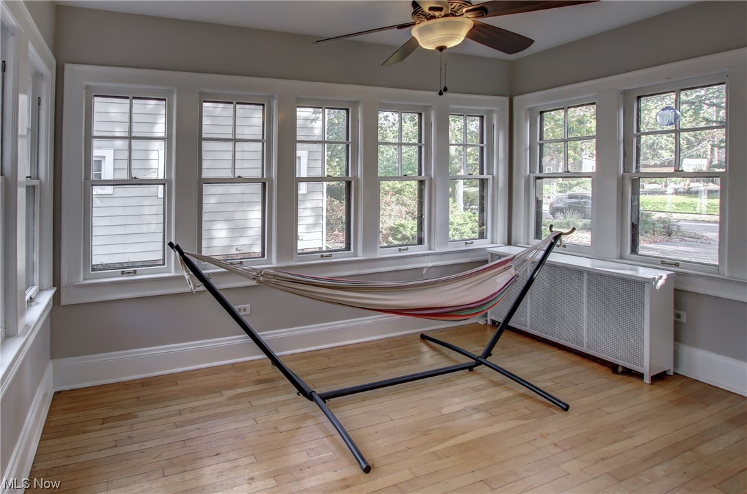 15911 Fernway Road Cleveland, OH 44120 - Photo 7 of 32 Sunroom with radiator heating unit and ceiling fan