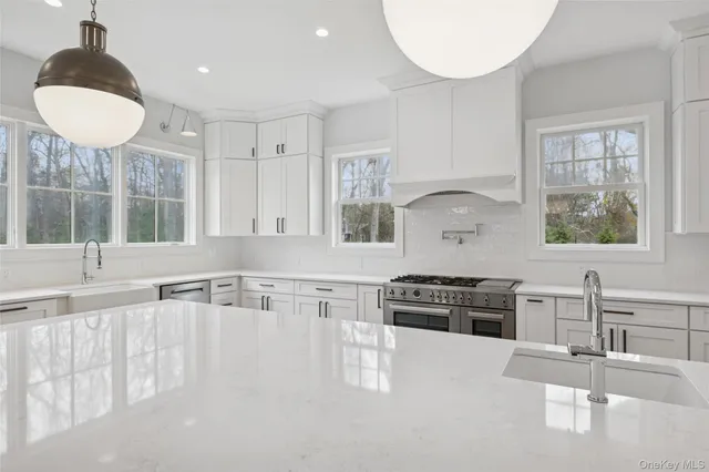 a kitchen with stainless steel appliances granite countertop a stove and a sink