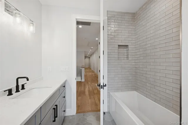 a bathroom with a bathtub and a sink