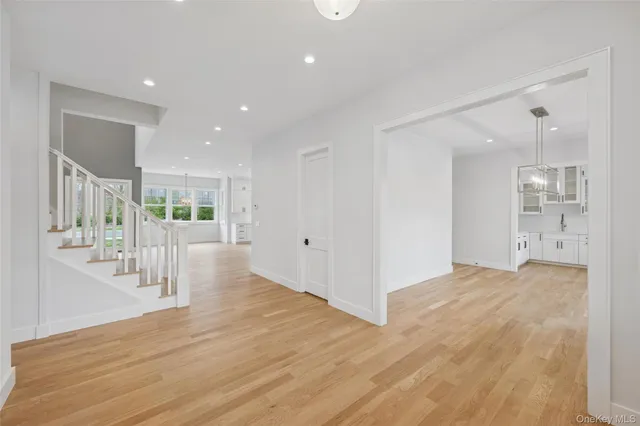 a view of an entryway with wooden floor and windows