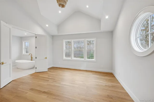 a big room with wooden floor and windows