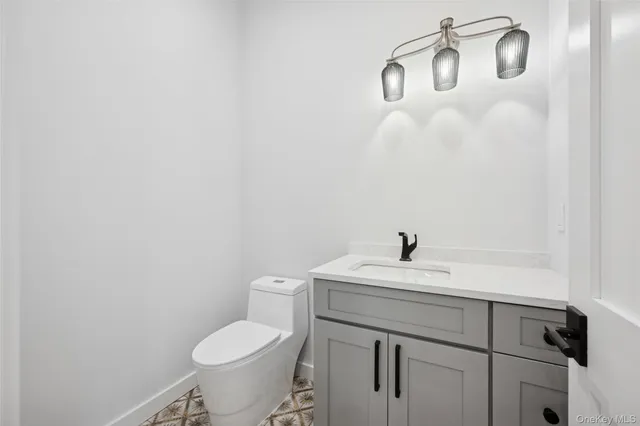 a bathroom with a sink mirror and toilet