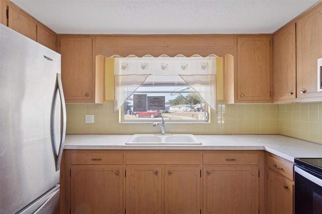7608 Redcoat Avenue Port Richey, FL 34668 - Photo 11 of 28 a bathroom with a sink and a refrigerator