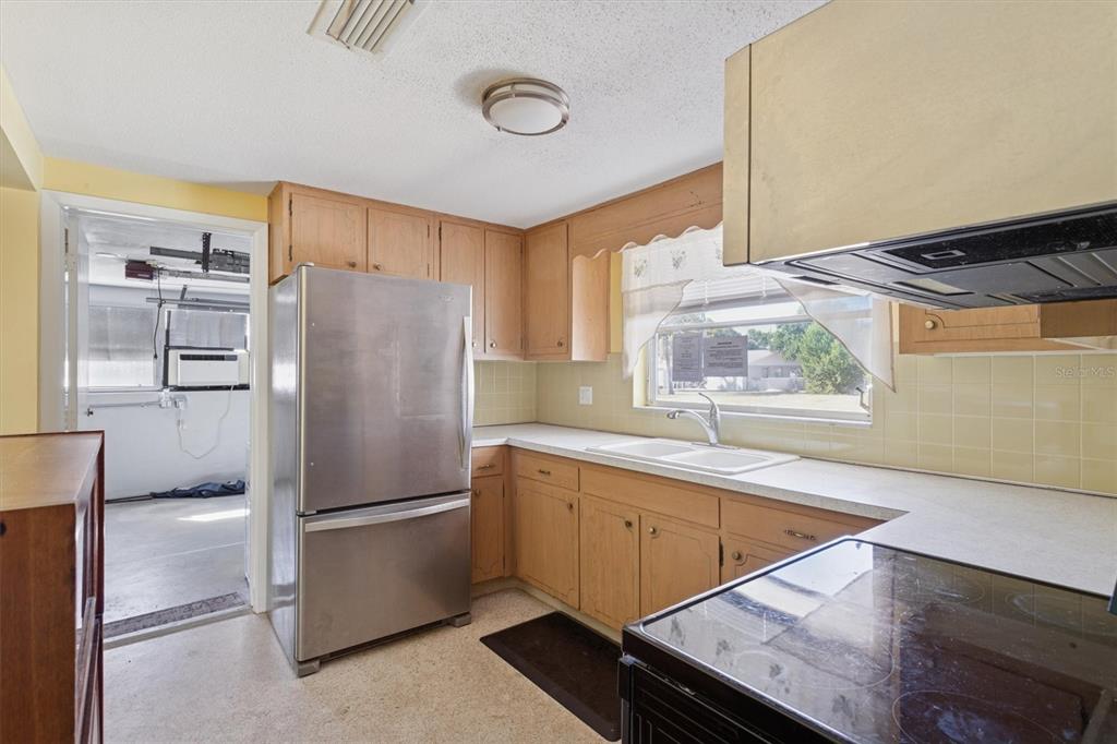 7608 Redcoat Avenue Port Richey, FL 34668 - Photo 12 of 28 a kitchen with stainless steel appliances a refrigerator and a sink