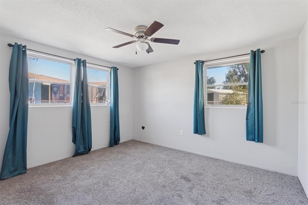 7608 Redcoat Avenue Port Richey, FL 34668 - Photo 13 of 28 an empty room with windows and closet