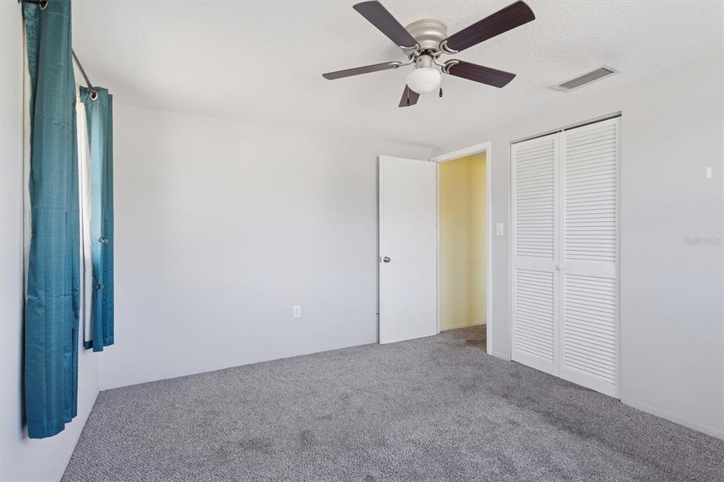7608 Redcoat Avenue Port Richey, FL 34668 - Photo 14 of 28 an empty room with a ceiling fan and a window