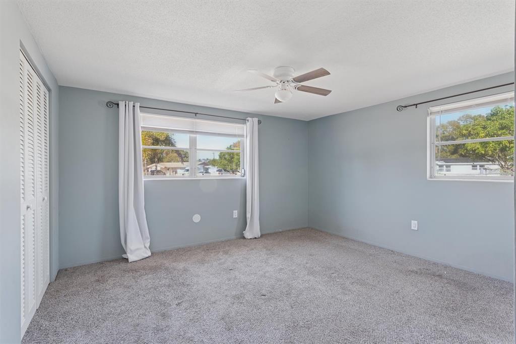 7608 Redcoat Avenue Port Richey, FL 34668 - Photo 15 of 28 an empty room with windows and closet