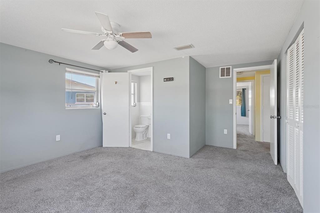 7608 Redcoat Avenue Port Richey, FL 34668 - Photo 16 of 28 a view of an empty room with a ceiling fan and window