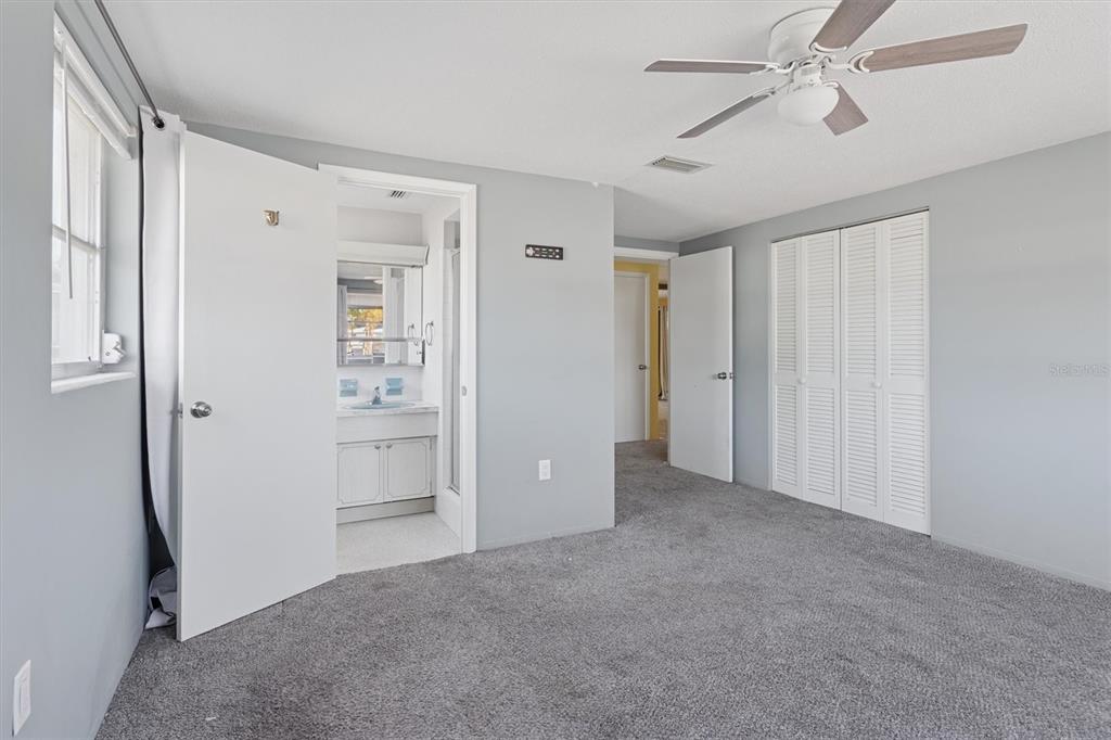 7608 Redcoat Avenue Port Richey, FL 34668 - Photo 17 of 28 an empty room with closet and a ceiling fan