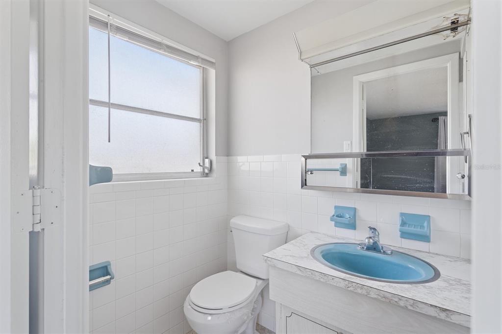 7608 Redcoat Avenue Port Richey, FL 34668 - Photo 18 of 28 a bathroom with a toilet a sink and mirror