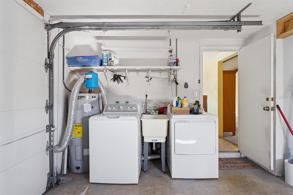 7608 Redcoat Avenue Port Richey, FL 34668 - Photo 23 of 28 a utility room with dryer and washer