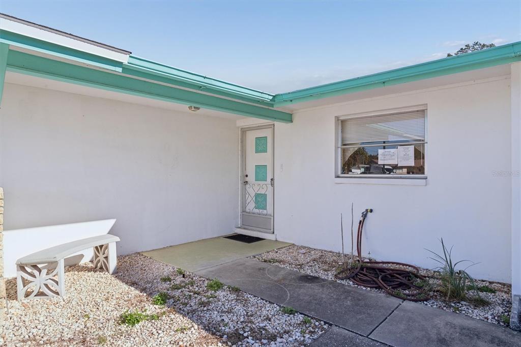 7608 Redcoat Avenue Port Richey, FL 34668 - Photo 5 of 28 a bedroom with a bed and a window