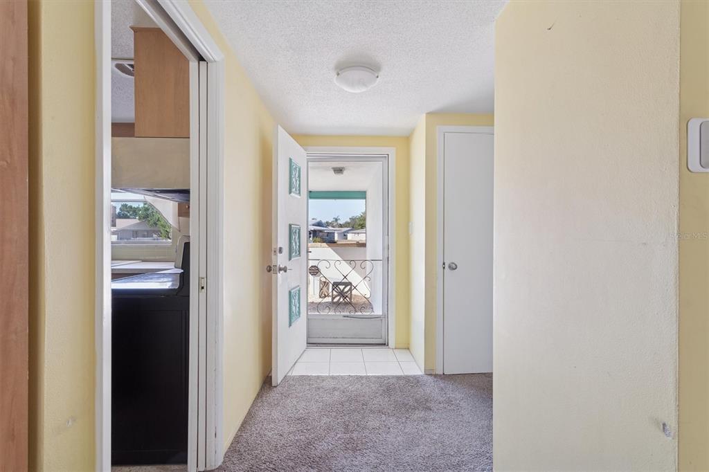 7608 Redcoat Avenue Port Richey, FL 34668 - Photo 6 of 28 a view of a hallway view with wooden floor and a bathroom