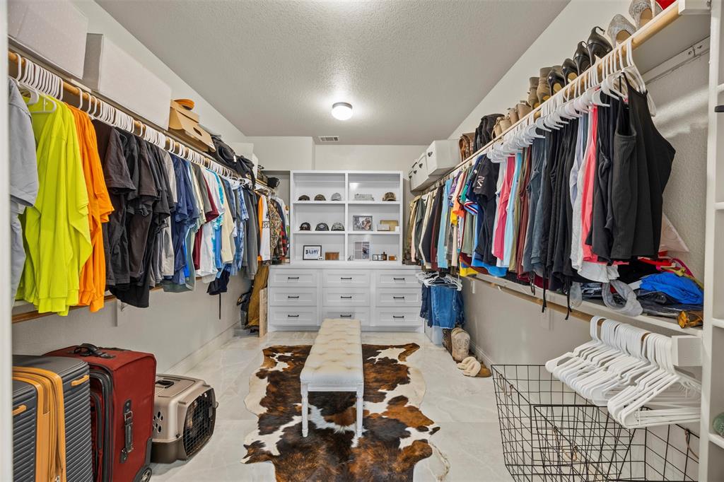 3175 Collins Road Burleson, TX 76028 - Photo 25 of 40 a view of walk in closet with clothes