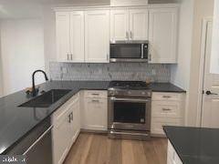 603 Parker Boulevard Princeton Junction, NJ 08540 - Photo 1 of 7 a kitchen with stainless steel appliances granite countertop a stove a sink and a microwave