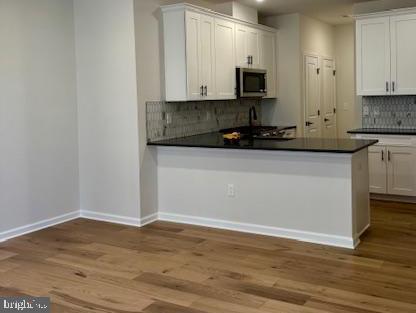 603 Parker Boulevard Princeton Junction, NJ 08540 - Photo 3 of 7 a kitchen with granite countertop white cabinets and a sink