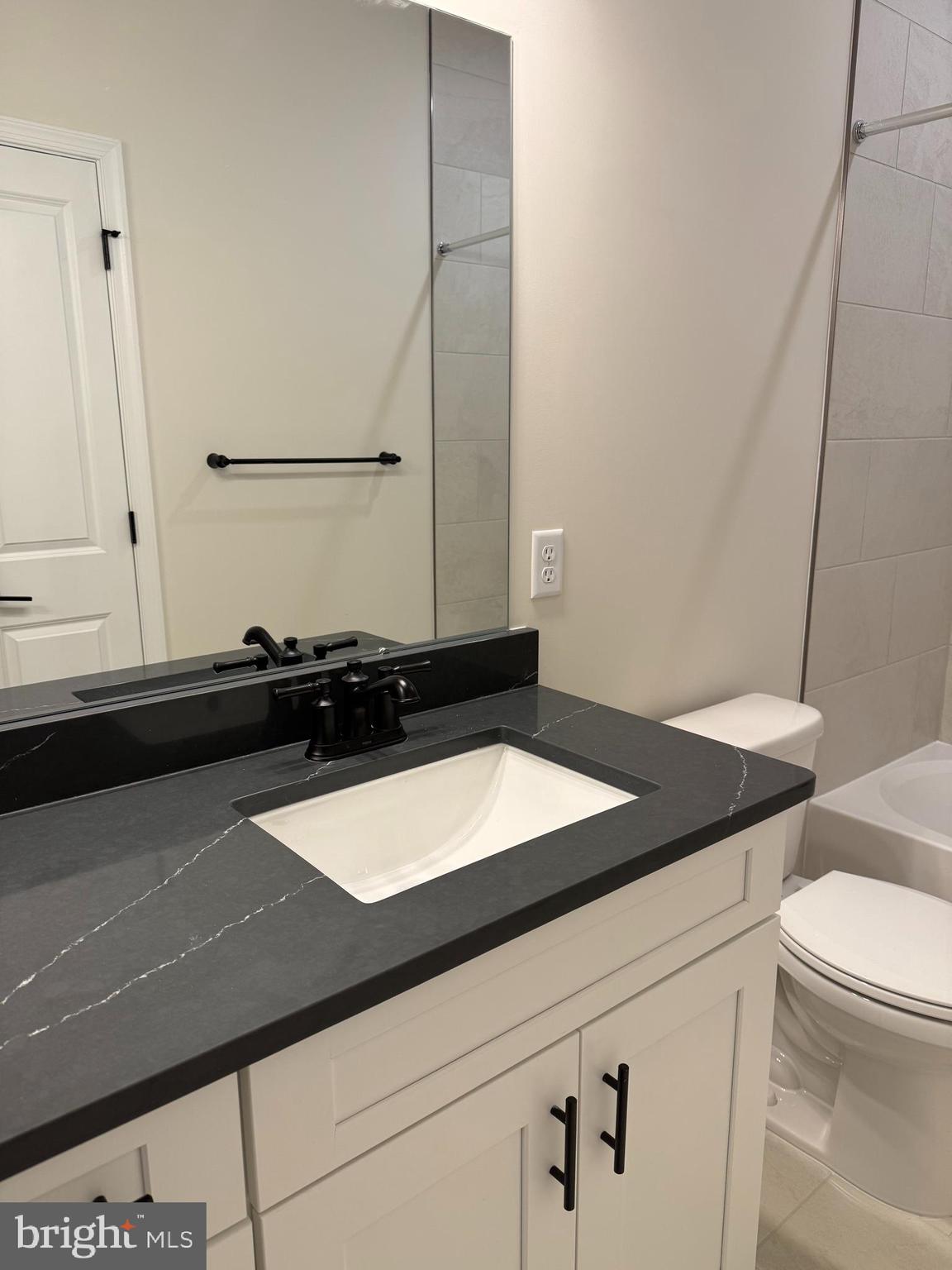 603 Parker Boulevard Princeton Junction, NJ 08540 - Photo 5 of 7 a bathroom with a granite countertop sink and a mirror