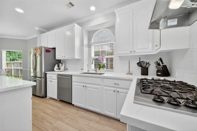 a kitchen with a sink stove and refrigerator