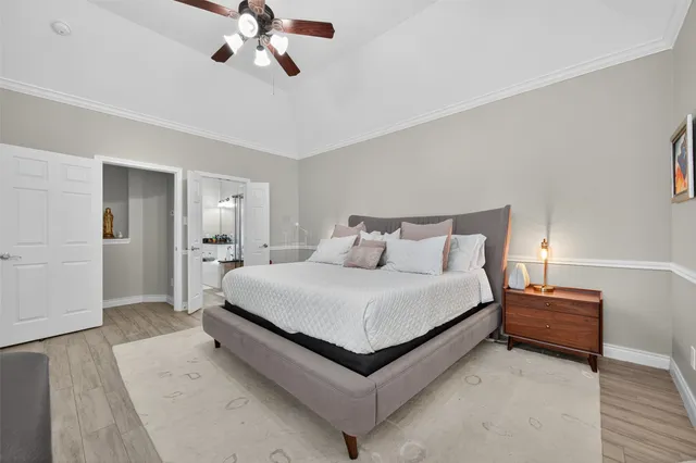 a bedroom with bed and a chandelier